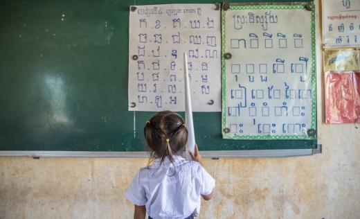 A girl stands at the blackboard in Cambodia