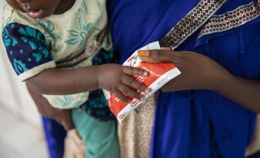 Amina and her daughter Fatima* holding Plumpy'Nut RUTF at the Stabilisation Centre, Gardo General Hospital, Somalia