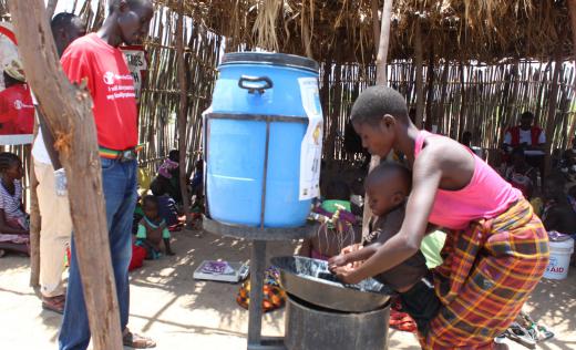 Rebecca, from Central Turkana, washing hands of her child to curb the spread of Covid-19