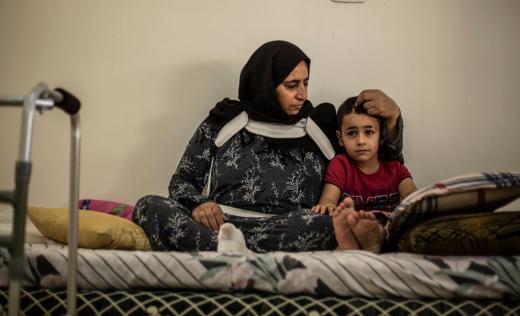 Said*, 6, is comforted by his mother Em Mahmoud at their home in Beirut