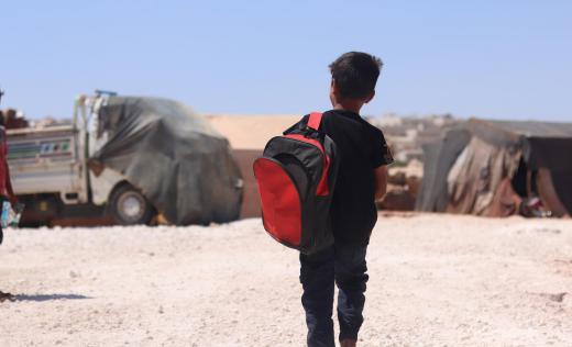 Anwar*, 7, on his way to school in a camp in North West Syria
