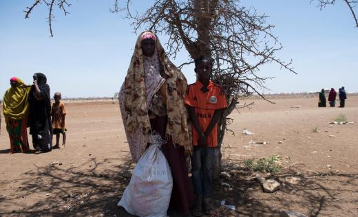Leylo*, 28, photographed with her four-month-old son, Assad*, and her 12-year-old son, Yuusuf*, in a camp in Baidoa