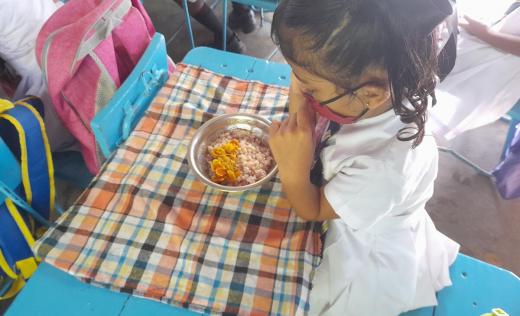 Children eat their daily school meal in Ratnapura District, Sri Lanka