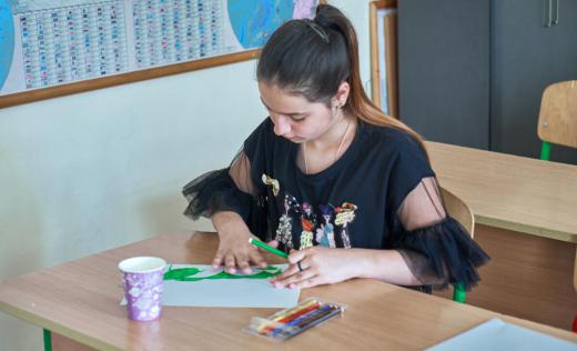 Kramatorsk railway station survivor Zoriana*, 12, is drawing her home in Kramatorsk at her school in a village in western Ukraine