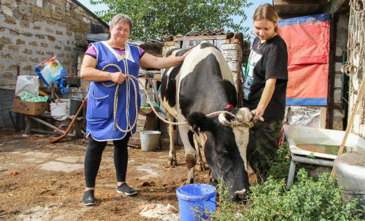 Oksana and Lana with cow in Mykolaiv