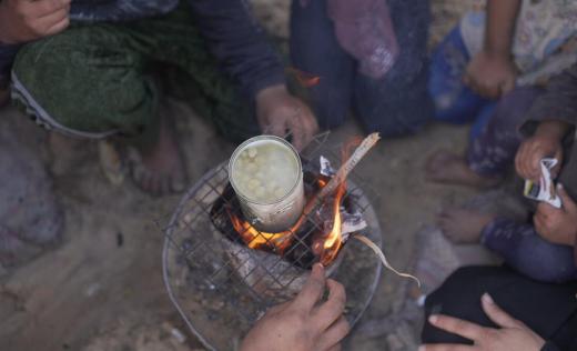several people have one can of food to share in Gaza
