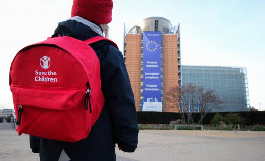 Child outside European commission with back to school kit