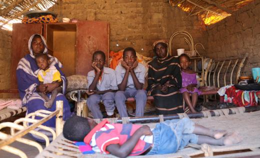 Montaser, 14 (centre), with his family in their home in Khartoum. Photo credit: Katharina von Schroeder/Save the Children.