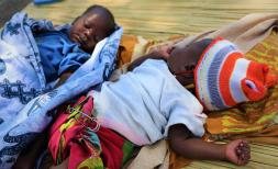 Aminda and Lucia, 1 month old twins sleeping outside their family's home in Mozambique
