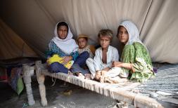 Noor with her children, inside her waterproof tent provided by Save The Children, Sindh, Pakistan