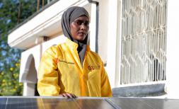 Luul, 23, in front of a solar panel in Somalia