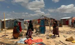 Women building a shelter at displacement camp in Somalia