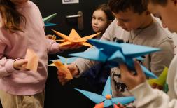 children playing with paper toys in Romania