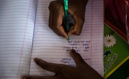 Child writes in school book