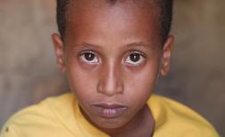 A portrait of Zaid*, 9, in his home near Taiz, Yemen