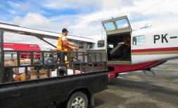 aid leaves timika for puncak on a plane